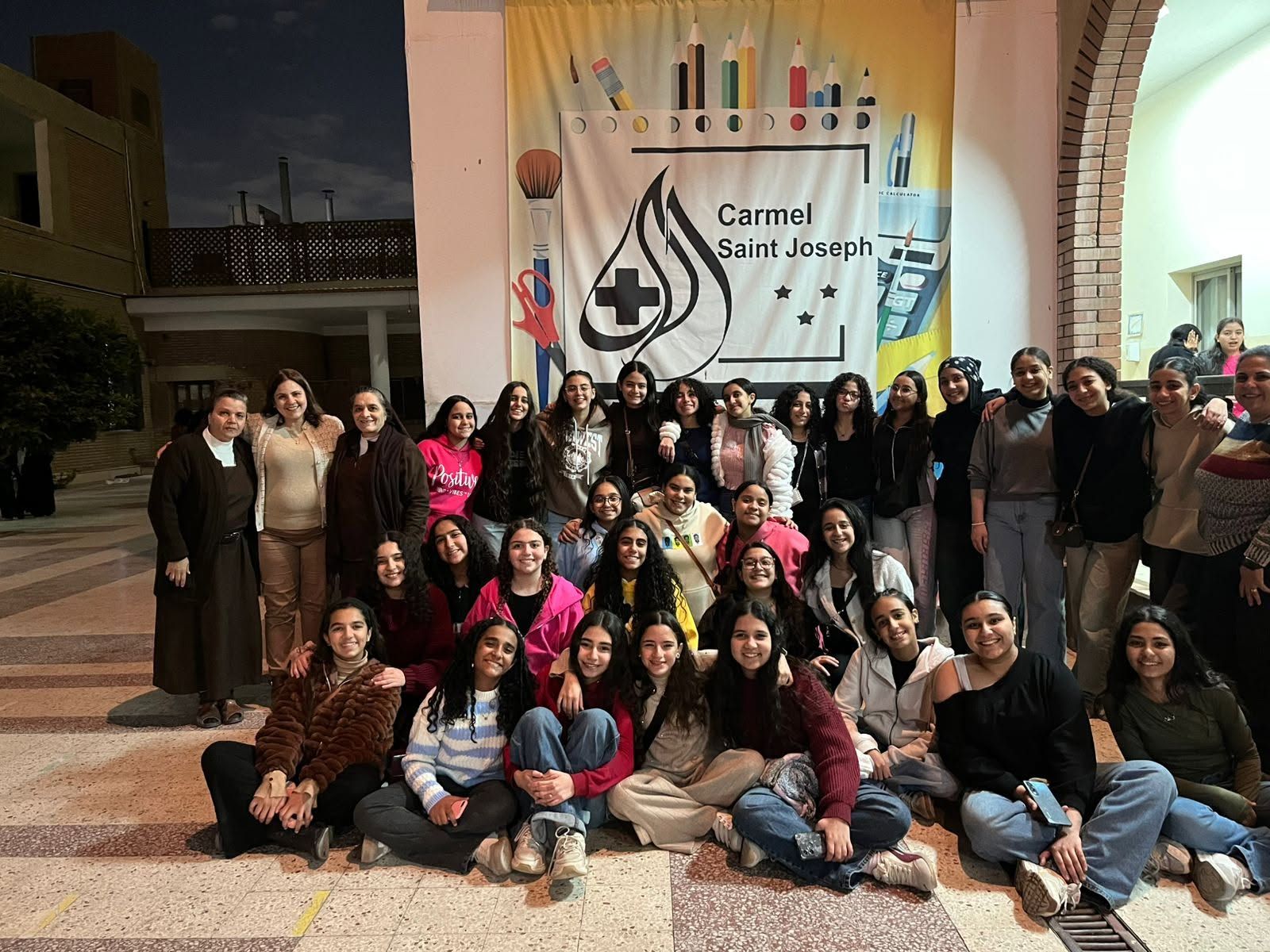 Students and sisters of Carmel Saint Joseph gathered in the school courtyard